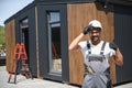 Construction worker gesturing thumbs up near modular house Royalty Free Stock Photo
