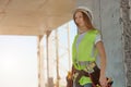 Construction worker girl with safety belt and tool Royalty Free Stock Photo