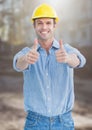 Construction Worker giving thumbs up in front of construction site Royalty Free Stock Photo
