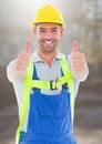 Construction Worker giving thumbs up in front of construction site Royalty Free Stock Photo