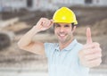 Construction Worker giving thumbs up in front of construction site Royalty Free Stock Photo