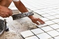 Construction site worker glued ceramic tile floor