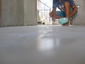 A construction worker grunting the ceramic tile floor - tiling work