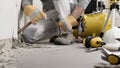 Construction worker hands with gloves working with hammer and chisel to remove old plaster from wall for house renovation, close Royalty Free Stock Photo