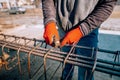 Construction worker - hands securing steel bars with wire rod for reinforcement of concrete Royalty Free Stock Photo