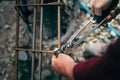 Construction worker - hands securing steel bars with wire rod for reinforcement of concrete Royalty Free Stock Photo