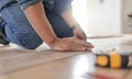 Construction worker hands, wood carpenter and home floor renovation of a builder. Working, woodwork and handcraft of a