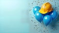 Construction worker helmet sits atop bunch of blue balloons. Confetti decorates light blue background. Image celebration of Royalty Free Stock Photo