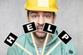 Construction worker holding a blackboard with space for text or text, copy space Royalty Free Stock Photo