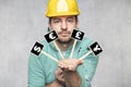 Construction worker holding a blackboard with space for text or text, copy space, he asks for a donation, front view Royalty Free Stock Photo