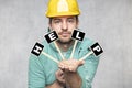 Construction worker holding a blackboard with space for text or text, copy space, he asks for help Royalty Free Stock Photo