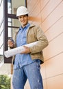 Construction worker holding cell phone