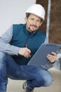 construction worker holding clipboard at home Royalty Free Stock Photo