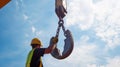 Construction Worker Holding Crane Hook Against Cloudy Sky Royalty Free Stock Photo