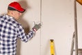 Construction worker holding gypsum board. Attic renovation. Inst