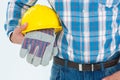 Construction worker holding hard hat and gloves Royalty Free Stock Photo