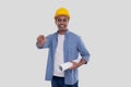 Construction Worker Holding House Plan in Hands Pointing in Camera. Architect Holding Blueprints. Yellow Hard Helmet Royalty Free Stock Photo