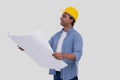 Construction Worker Holding House Plan in Hands Watching up. Architect Holding Blueprints. Yellow Hard Helmet Royalty Free Stock Photo