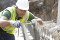 Construction Worker Holding Measure