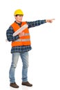 Construction worker holding rolled paper plan and pointing. Royalty Free Stock Photo