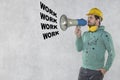 The construction worker holds a megaphone in his hands, the concept of issuing orders