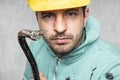 The construction worker holds a work tool in his hands, a crowbar Royalty Free Stock Photo