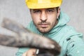 The construction worker holds a work tool in his hands, a crowbar Royalty Free Stock Photo