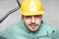 The construction worker holds a work tool in his hands, a crowbar Royalty Free Stock Photo