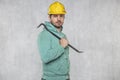 The construction worker holds a work tool in his hands, a crowbar Royalty Free Stock Photo