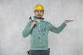 The construction worker holds a work tool in his hands, a crowbar, copy space above the hand