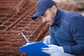 construction worker inspecting metal bar Royalty Free Stock Photo