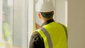 A construction worker inspects the wall of a building on a construction site. Royalty Free Stock Photo