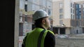 A construction worker inspects the wall of a building on a construction site. Royalty Free Stock Photo