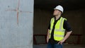 A construction worker inspects the wall of a building on a construction site. Royalty Free Stock Photo