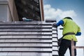 Construction worker install install new ceramic tile roof, Roofing tools, Electric drill used on new roofs on construction site