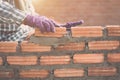 Worker installing bricks wall in process of house building Royalty Free Stock Photo