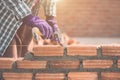 Worker installing bricks wall in process of house building Royalty Free Stock Photo