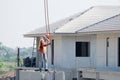 Construction worker are installing Crane hooks at the precast concrete wall, Precast house. Royalty Free Stock Photo