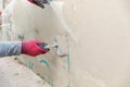 Construction worker installing fiberglass plaster mesh on the wall