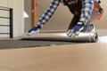 Construction worker installing laminate floor in a new renovated attic. Home improvement concept