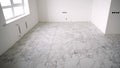 Tiler installing marble tiles on floor Royalty Free Stock Photo