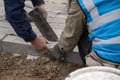 Construction worker installing and laying pavement stones on terrace, road or sidewalk Royalty Free Stock Photo