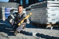Construction worker installing and laying pavement stones on terrace, road or sidewalk. Worker using stones and rubber Royalty Free Stock Photo