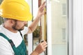 Construction worker installing new window Royalty Free Stock Photo