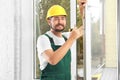 Construction worker installing new window Royalty Free Stock Photo