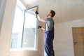 Construction worker installing new window in house Royalty Free Stock Photo