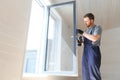 Construction worker installing new window in house Royalty Free Stock Photo