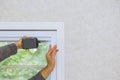 Construction worker installing new window in house using a screwdriver Royalty Free Stock Photo