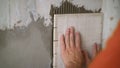 Construction worker installing small ceramic tiles on the wall. Royalty Free Stock Photo