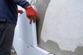 Construction worker installing styrofoam insulation sheets on house facade wall for thermal protection Royalty Free Stock Photo